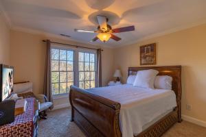 a bedroom with a bed and a ceiling fan at Pisgah Retreat at Linville Falls in Linville Falls