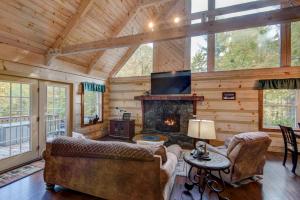 a living room with a fireplace in a log cabin at Serenity Now in Fleetwood