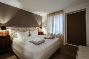 A bed or beds in a room at Ulivo Suites - apartments