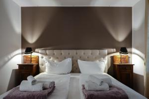 A bed or beds in a room at Ulivo Suites - apartments