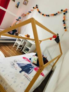 a bed with a wooden frame in a room at Chez Moi in Chemin Grenier