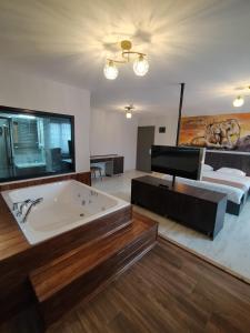 a large bathroom with a tub and a bed at SAR-PER Hotel in Edirne