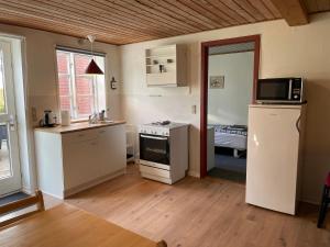 una cucina con lavandino e piano cottura forno superiore di Kragh B&B a Løsning Altre 14 foto