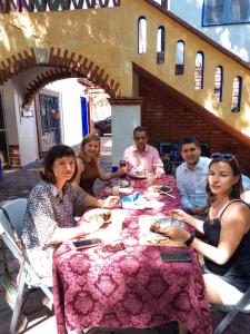 a group of people sitting around a table at La lagartija in San Pablo Etla