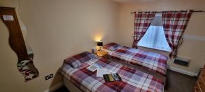 a small bedroom with a bed and a window at Town House B & B in Skipton