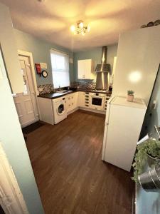 a kitchen with a white refrigerator and a stove at Rooms Anfield- 5 mins from LFC in Liverpool