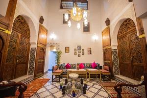 a living room with a couch and tables in a building at Medina Sky in Fès