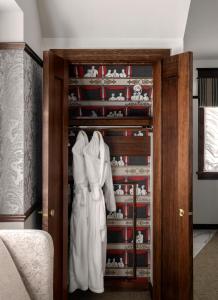 a closet with two white dresses in it at Abigail's Hotel in Victoria