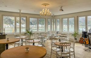 a restaurant with tables and chairs and a chandelier at Hotel zum Goldenen Löwen - Restaurant - Panoramabar - Terrassen - Events - Rheinblick - Geschichte seit 1728 in Sankt Goar