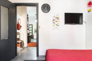 a room with a bed and a tv on a wall at People LOVE this home! in Haifa