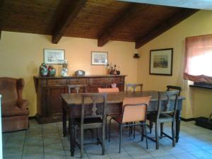 a dining room with a wooden table and chairs at B&B Casa Dolce Casa in Candelo