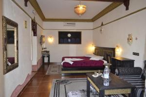 una camera con letto e tavolo di Riad Ambelar a Erfoud