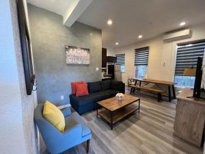 a living room with a blue couch and a table at The Red Guest House in Downtown Los Angeles in Los Angeles