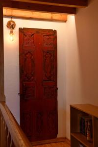 a large red door in a room with a staircase at The three story old town house in Rhodes Town