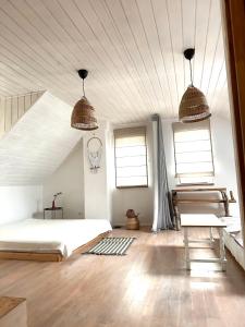 a bedroom with a bed and two windows at Domek nad Śniardwami in Suchy Róg