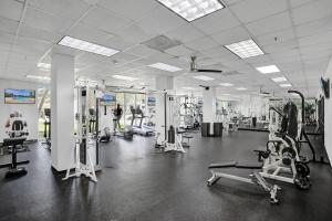 a gym with several machines and people in it at Ocean Reserve Condominium in Miami Beach