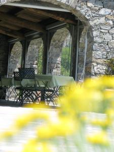 a table and chairs on a stone patio at Sostio a Levante in Framura