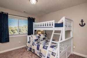 a bedroom with a white bunk bed and a ladder at Castaway in Caswell Beach +82 photos