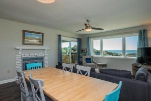 a living room with a table and a couch at Castaway in Caswell Beach