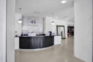 a lobby with a black and white counter in a building at Ocean Reserve Condominium in Miami Beach