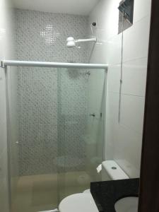 a bathroom with a glass shower with a toilet at POUSADA CECILIA in Canindé de São Francisco