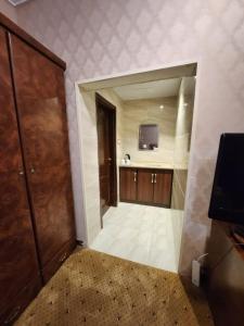 a large bathroom with a sink and a wooden door at فندق شموخ السعد in Mecca
