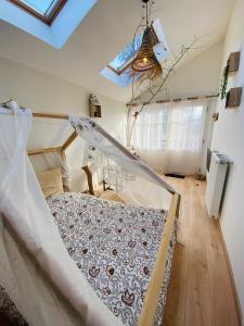 a bedroom with a bed in a room with a ceiling at Le Nid Douillet in Plancher-Bas