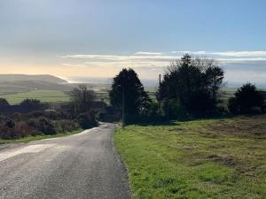 an empty road in the middle of a field at Idyllic holiday near Abersoch in Mynytho