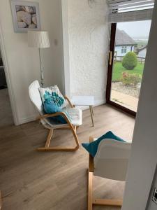 a living room with a chair and a lamp at Idyllic holiday near Abersoch in Mynytho