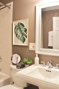 a bathroom with a sink and a toilet and a mirror at Luxury - Pet Friendly 3bd, 3ba South End Condo in Boston
