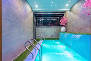 a lap pool in a room with a bar at Cecilia Homes in Lekki