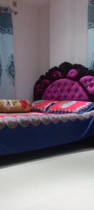a shelf with purple pillows on top at Stunning 1-Bed Apartment in Dhaka close to airport in Dhaka