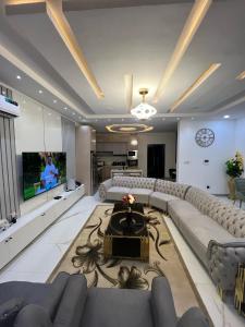 a large living room with a couch and a tv at Cecilia Homes in Lekki