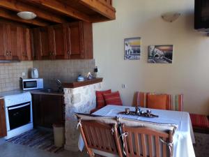 a kitchen with a table with a sink and a stove at Mika's House in Halki