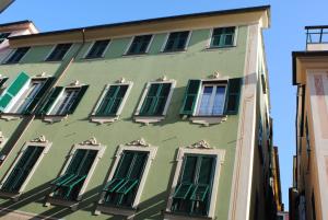 a green building with green shutters on it at Il Sogno Maison de Charme in Chiavari
