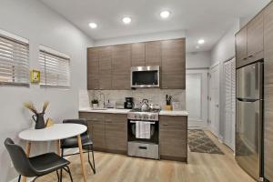 una cocina con una mesa y una estufa horno superior en Comfortable & Furnished Studio Apt with Wi-Fi - Magnolia CH, en Chicago