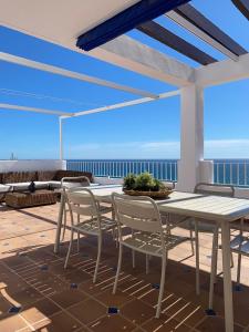 a table and chairs on a patio with a view of the ocean at RESIDENCIAL OASIS 3 in Mojácar
