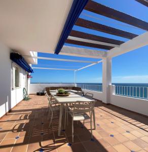 a balcony with a table and chairs and the ocean at RESIDENCIAL OASIS 3 in Mojácar