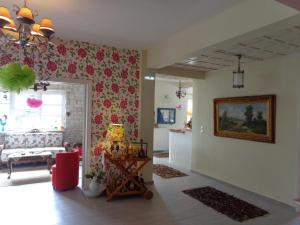 a living room with red flowers on the wall at Odos Kentavron in Tsagarada