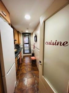 a kitchen with a door with the word cuisine on it at Coqueto apartamento en Las margas golf in Sabiñánigo