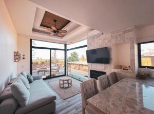 a living room with a couch and a table and a television at Penthouse at Hotel Boutique Valle de Guadalupe in Valle de Guadalupe