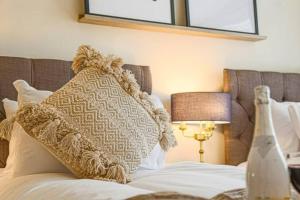 a bed with a pillow on top of it at Lowndes House - Close to City Centre - Garden, Free Parking and Smart TV by Yoko Property in Milton Keynes