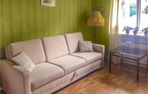 a living room with a couch and a table at One-Bedroom Holiday Home In Roke in Röke