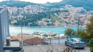 a car parked in a parking lot next to a body of water at Apartment Piano in Dubrovnik