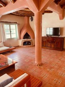 a living room with a large room with a fireplace at Les Villas de Nouran 7chambres in Ghazoua +23 photos