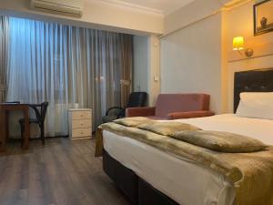 A bed or beds in a room at Taksim House Suites