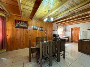 a kitchen with wooden walls and a table in a room at Cabañas Lupita in Mazamitla