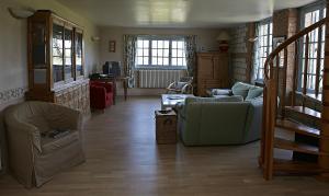 a living room with a couch and chairs and a table at Gîte du Presbytère de L'Abbé L'Hermina in Saint-Martin-le-Gaillard