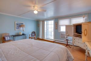 a bedroom with a large bed and a television at Beach Walk on the Ocean in Ocean City