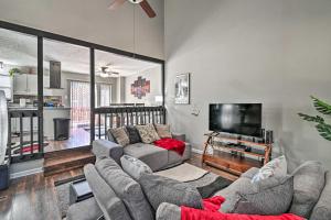 a living room with a couch and a tv at Updated Fayetville Townhome-Away-From-Home with Yard in Fayetteville